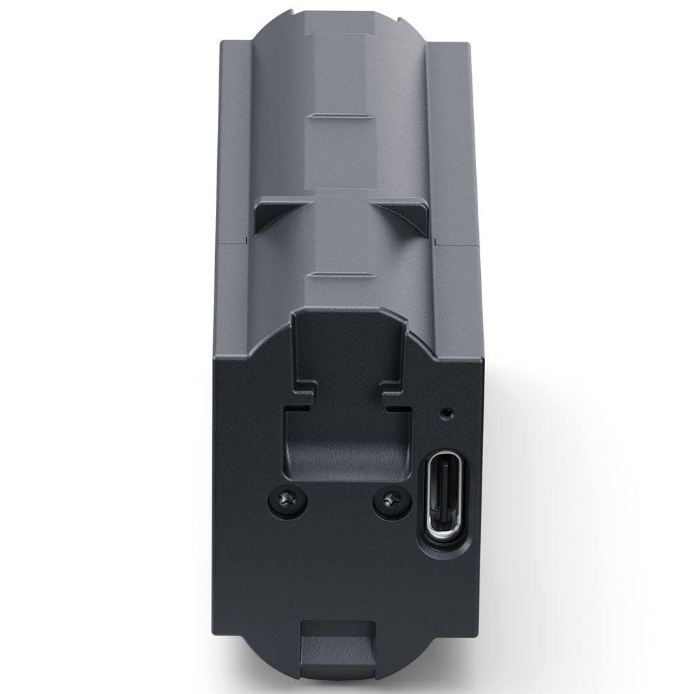A dark gray rectangular electronic device with a USB-C port on the side, shown from a top-down angle on a white background.