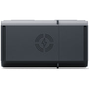 A dark gray rectangular electronic device with a matte finish, featuring a circular lightning bolt symbol inside concentric rings on the front center, set against a plain white background.