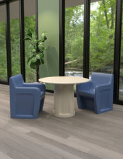 Cortech Sentinel arm chairs with molded cylinder base table in a correctional dayroom