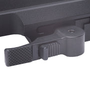 Close-up of a black plastic latch on a textured surface