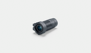 A compact black cylindrical camera lens or optical module with a textured grip and a clear front lens, shown on a clean light gray background.