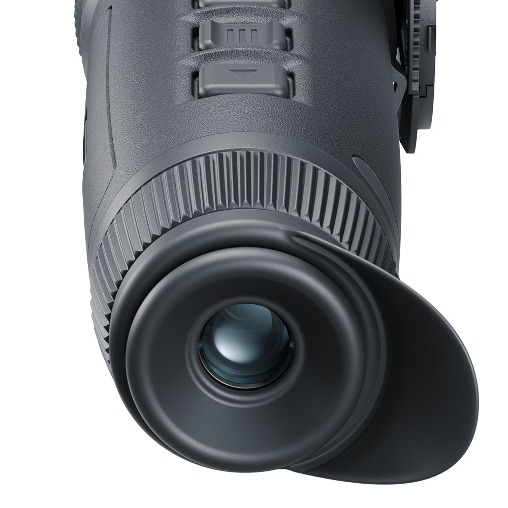 Close-up of a black monocular on a white background