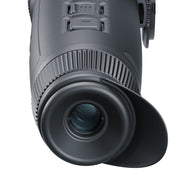 Close-up of a black monocular on a white background
