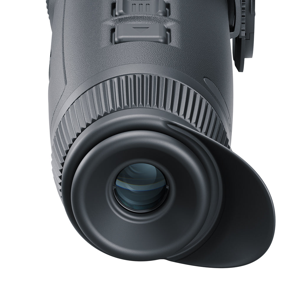 Close-up of a black monocular on a white background