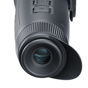 Close-up of a black monocular on a white background