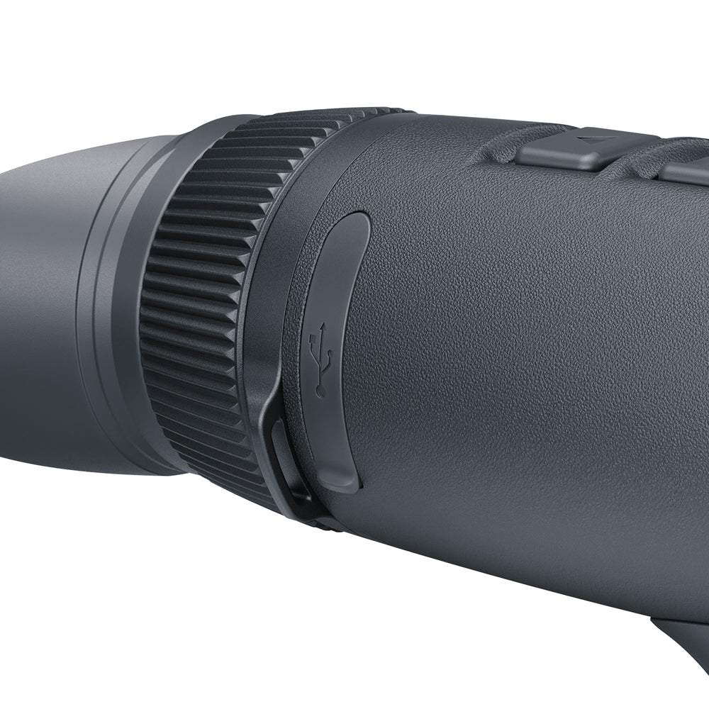 Close-up of a dark gray textured monocular or binocular eyepiece with a ribbed focusing ring and side buttons, shown against a plain white background.