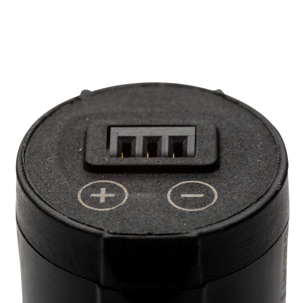 Close-up of the top of a black cylindrical electronic device showing a multi-pin connector with positive and negative terminal markings on a white background.