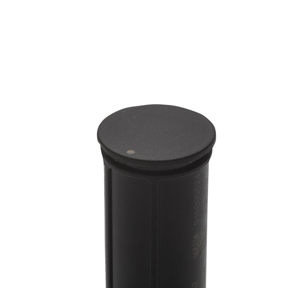 Black cylindrical object with a round top on a white background