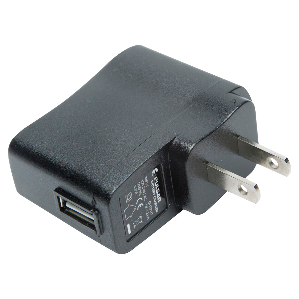 A black USB wall charger adapter with a two-prong US plug, featuring a USB-A port on one side and a printed label with regulatory information on the side.