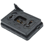 A black plastic camera accessory mount or grip module with gold metal contacts visible in the center, shown on a plain white background.