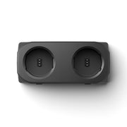 Black electronic device with two circular ports on a white background