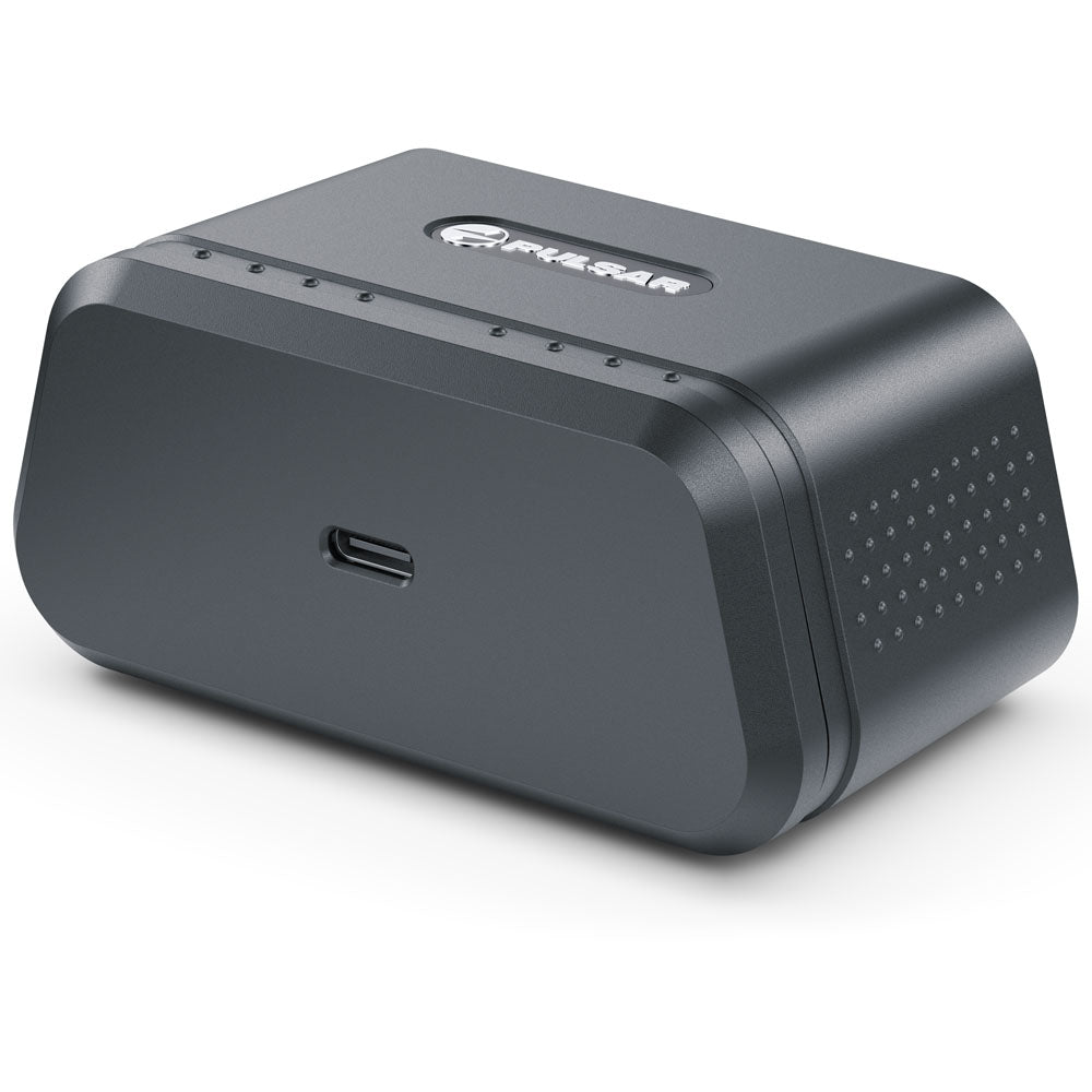 A dark gray rectangular electronic device with rounded corners, featuring a USB-C port on the side and a logo on top, photographed on a white background.