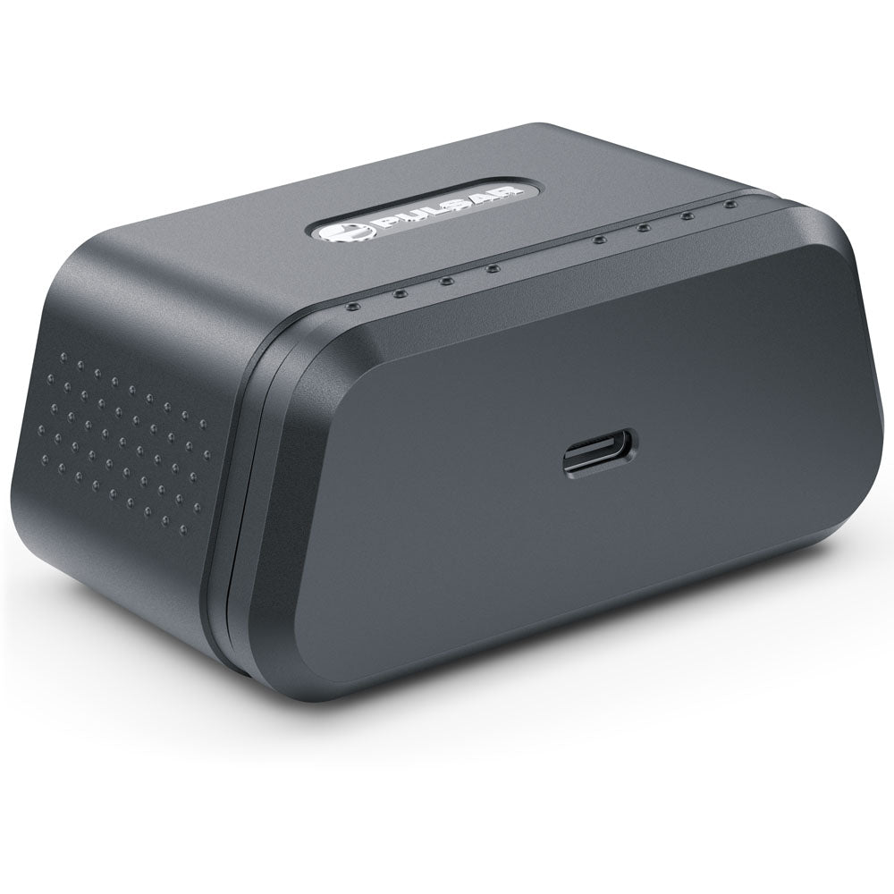 A dark gray rectangular electronic device with rounded corners, featuring a USB-C port on the front, a speaker grille on the side, and a small logo plate on top, shown on a white background.