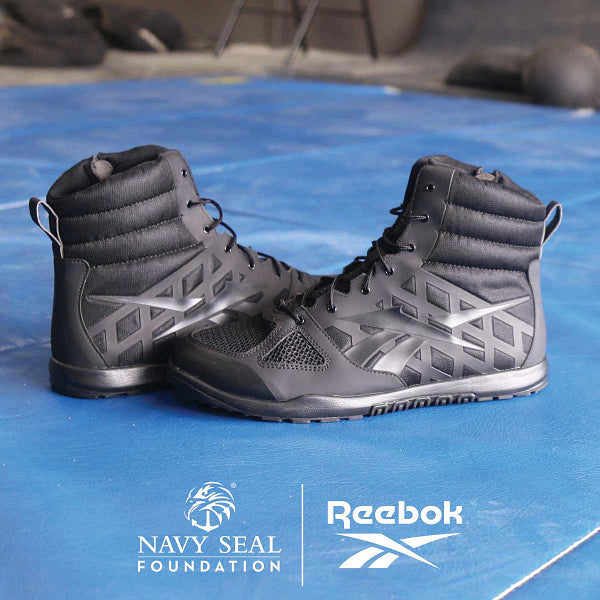 Black Reebok Nano Tactical Boots on a blue surface with Reebok and Navy SEAL Foundation logos