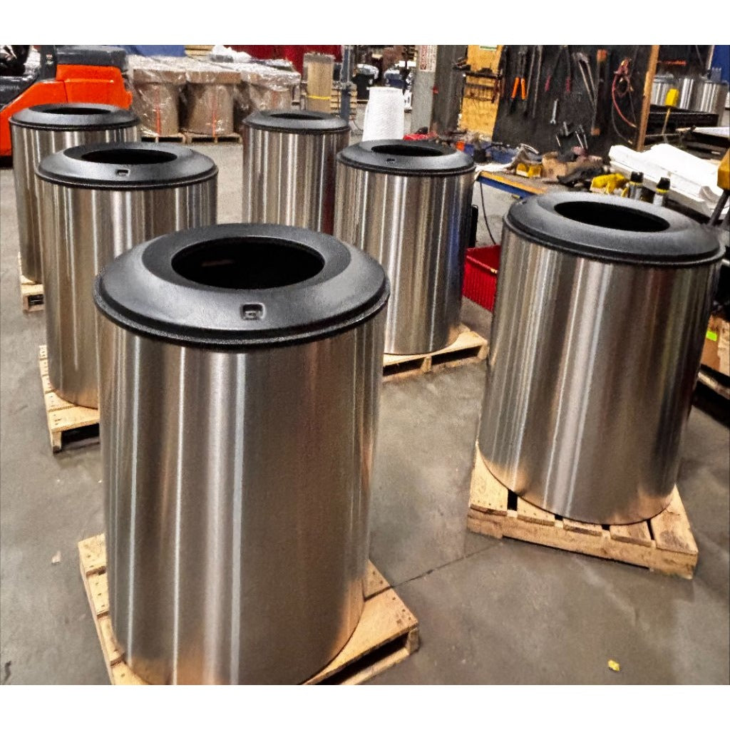 Six stainless Mistral blast containment receptacles on pallets during production