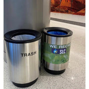 Two stainless blast containment receptacles in airport terminal concourse interior